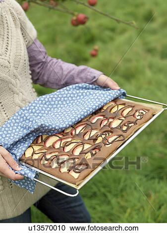 Woman carrying applecake tray View Large Photo Image Stock Image - Woman carrying applecake tray. Fotosearch
