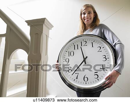 Woman climbing the stairs with a clock View Large Photo Image Stock Image - Woman climbing the stairs with a clock. Fotosearch