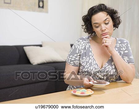 Woman comparing sweets. View Large Photo Image Stock Image - Woman comparing sweets.. Fotosearch