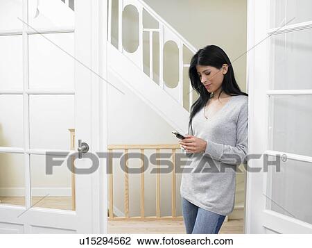 Woman dialing a number on her cellphone View Large Photo Image Stock Image - Woman dialing a number on her cellphone. Fotosearch
