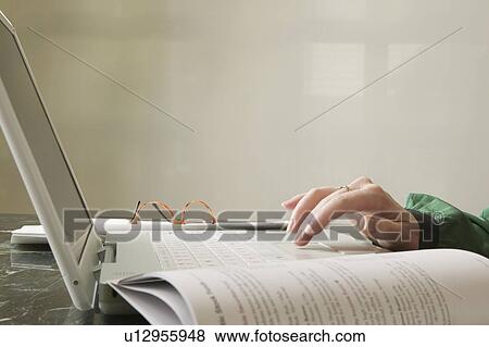 Stock Photo - Woman doing financial planning online. Fotosearch