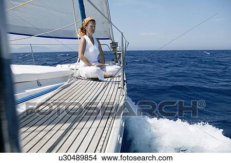 Picture - Woman doing yoga on Sailing Boat. Fotosearch