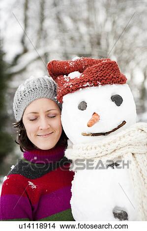 Picture - woman dreaming with snowman. Fotosearch