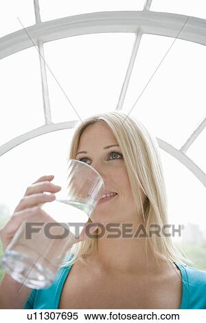 Woman drinking a glass of water. View Large Photo Image Stock Photography - Woman drinking a glass of water.. Fotosearch
