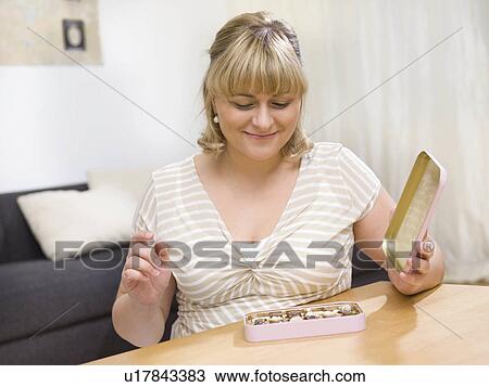 Woman eating chocolate View Large Photo Image Stock Image - Woman eating chocolate. Fotosearch