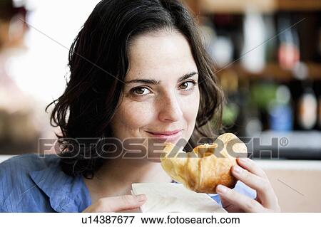 Woman Eating Croissant View Large Photo Image Stock Photo - Woman Eating Croissant. Fotosearch