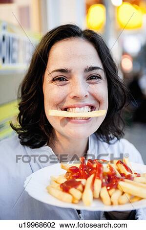 Woman Eating French Fries View Large Photo Image Stock Image - Woman Eating French Fries. Fotosearch