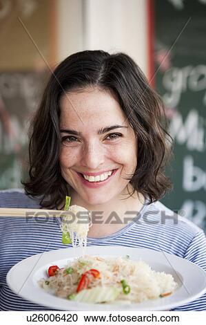 Woman Eating Noodles View Large Photo Image Stock Image - Woman Eating Noodles. Fotosearch