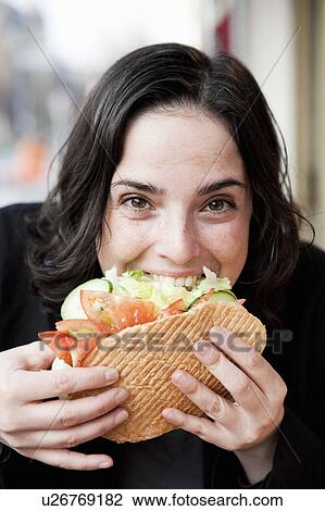 Stock Image - Woman Eating Sandwich. Fotosearch
