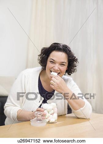 Woman eating sweets View Large Photo Image Stock Image - Woman eating sweets. Fotosearch
