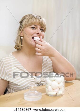 Woman eating sweets View Large Photo Image Stock Photo - Woman eating sweets. Fotosearch