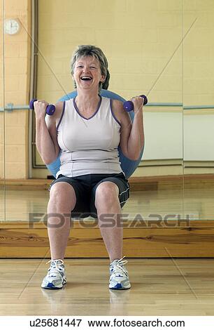 woman exercising with weights at gym View Large Photo Image Stock Photo - woman exercising with weights at gym. Fotosearch