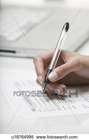 Woman filling out a tax form View Large Photo Image Stock Photography - Woman filling out a tax form. Fotosearch