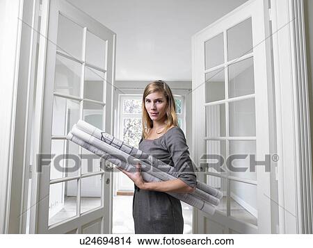 Woman holding blue prints View Large Photo Image Picture - Woman holding blue prints. Fotosearch