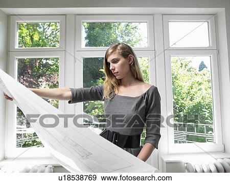 Woman holding blue prints View Large Photo Image Stock Photo - Woman holding blue prints. Fotosearch