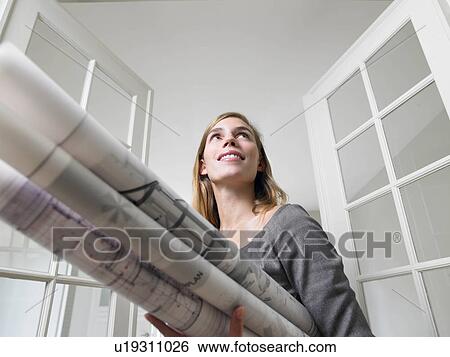Woman holding blue prints View Large Photo Image Stock Photograph - Woman holding blue prints. Fotosearch