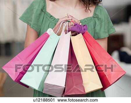 woman holding shopping bags View Large Photo Image Stock Image - woman holding shopping bags. Fotosearch