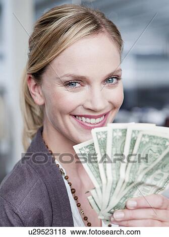 woman holding up dollar bills View Large Photo Image Stock Photo - woman holding up dollar bills. Fotosearch