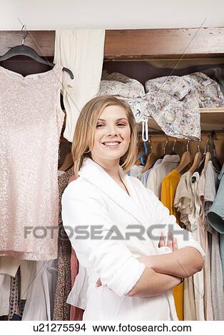 Woman in front of her closet View Large Photo Image Picture - Woman in front of her closet. Fotosearch