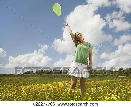 Woman in Meadow with Balloon View Large Photo Image Stock Photograph - Woman in Meadow with Balloon. Fotosearch