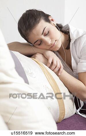 Woman listening to music View Large Photo Image Stock Photo - Woman listening to music. Fotosearch