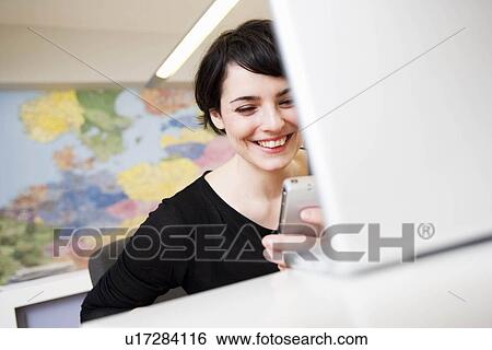 woman looking at cell phone View Large Photo Image Stock Photograph - woman looking at cell phone. Fotosearch
