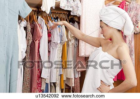 Stock Image - Woman looking at her clothes. Fotosearch