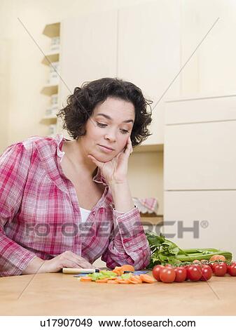 woman looking doubtfully at vegetables View Large Photo Image Stock Photo - woman looking doubtfully at vegetables. Fotosearch