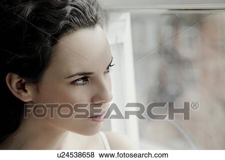 Woman looking through window. View Large Photo Image Stock Photo - Woman looking through window.. Fotosearch