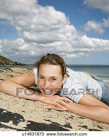 Woman Lying across Beach Rocks View Large Photo Image Stock Image - Woman Lying across Beach Rocks. Fotosearch