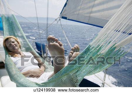 Woman lying in hammock on sailing boat View Large Photo Image Stock Photo - Woman lying in hammock on sailing boat. Fotosearch