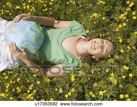 Woman Lying in Meadow with Globe View Large Photo Image Stock Image - Woman Lying in Meadow with Globe. Fotosearch
