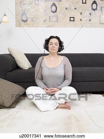 woman meditating, headphones on. View Large Photo Image Stock Image - woman meditating, headphones on.. Fotosearch