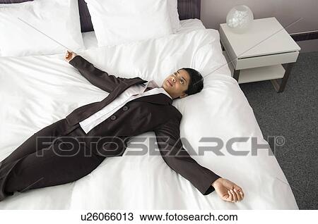 Woman on a bed with arms outstretched View Large Photo Image Stock Image - Woman on a bed with arms outstretched. Fotosearch