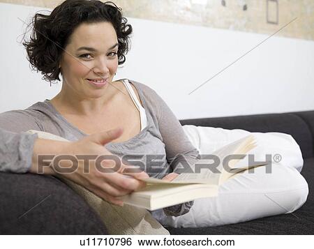 Woman on couch, reading. View Large Photo Image Stock Photograph - Woman on couch, reading.. Fotosearch