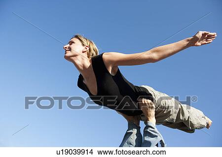 Picture - Woman Playing Air Plain. Fotosearch