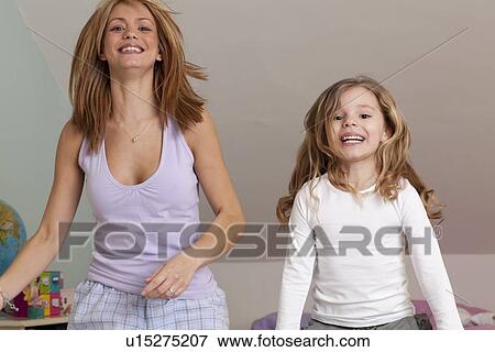 woman playing in bed with girl View Large Photo Image Stock Photo - woman playing in bed with girl. Fotosearch
