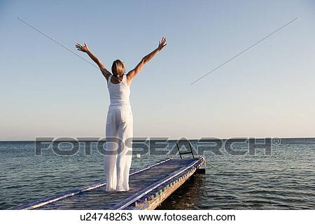 Stock Image - Woman Practicing Yoga. Fotosearch