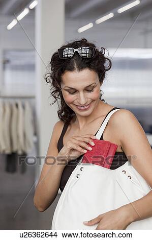 woman putting purse back in bag View Large Photo Image Picture - woman putting purse back in bag. Fotosearch