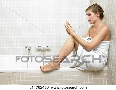 Woman reading a book in bathroom View Large Photo Image Stock Image - Woman reading a book in bathroom. Fotosearch