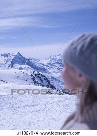 Picture - woman relaxing on sunny mountain top. Fotosearch