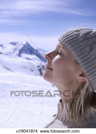 Picture - woman relaxing on sunny mountain top. Fotosearch