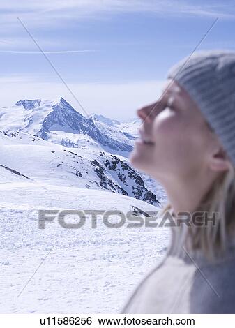 Stock Photograph - woman relaxing on sunny mountain top. Fotosearch