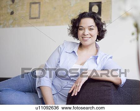 woman relaxing on the sofa. View Large Photo Image Stock Photograph - woman relaxing on the sofa.. Fotosearch