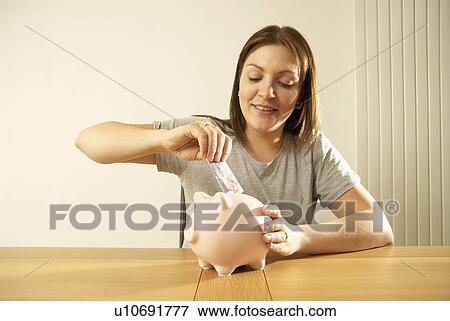 woman saving in piggy bank View Large Photo Image Stock Photo - woman saving in piggy bank. Fotosearch