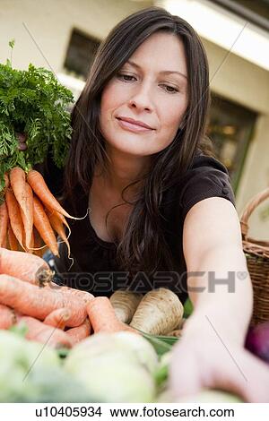 Woman shopping fresh vegetables View Large Photo Image Picture - Woman shopping fresh vegetables. Fotosearch