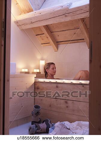 Stock Photograph - woman sitting in bath tub. Fotosearch