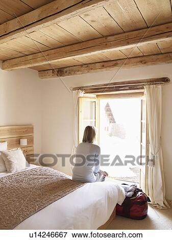 woman sitting on bed View Large Photo Image Stock Photo - woman sitting on bed. Fotosearch