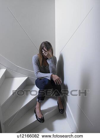 Woman sitting on stairs View Large Photo Image Stock Image - Woman sitting on stairs. Fotosearch