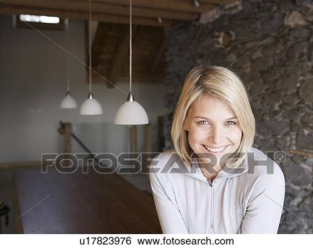woman smiling at viewer in room View Large Photo Image Stock Photograph - woman smiling at viewer in room. Fotosearch